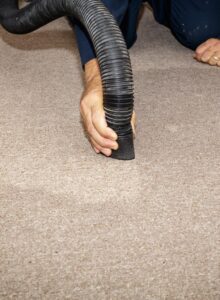 Using a wet/dry vac to remove water from a carpet after a slab leak