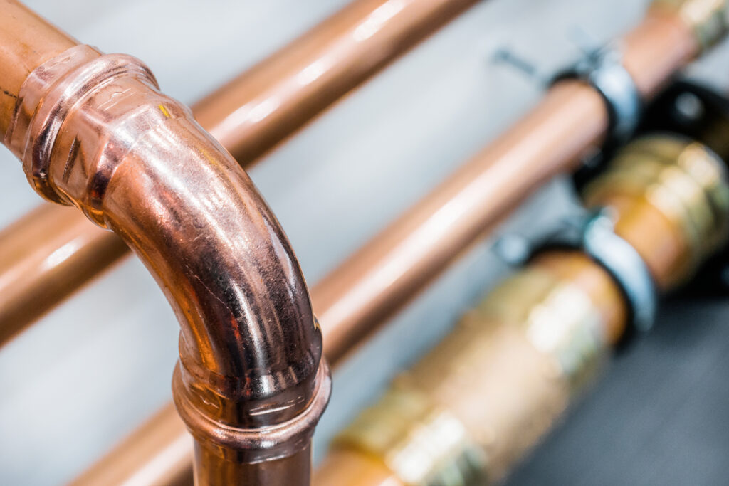Shiny new copper pipes, just installed in a residential space